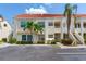 Inviting two-story condo featuring a red tile roof, lush landscaping, and convenient parking at 6171 Bahia Del Mar Blvd # 216, St Petersburg, FL 33715