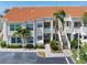 Condo exterior with beige stucco, terra cotta roof, lush landscaping and convenient parking at 6171 Bahia Del Mar Blvd # 216, St Petersburg, FL 33715