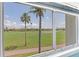 Scenic view of the golf course and palm trees as seen from the screened-in lanai at 6171 Bahia Del Mar Blvd # 216, St Petersburg, FL 33715