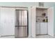 Kitchen storage area featuring a stainless steel refrigerator and a laundry closet at 6171 Bahia Del Mar Blvd # 216, St Petersburg, FL 33715