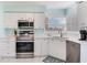 Bright kitchen with white cabinets, stainless steel appliances, and tile flooring at 6171 Bahia Del Mar Blvd # 216, St Petersburg, FL 33715