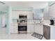 Bright kitchen with white cabinets, stainless steel appliances, and tile flooring at 6171 Bahia Del Mar Blvd # 216, St Petersburg, FL 33715