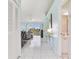 Bright, open-concept living room with tile flooring and sliding glass doors to balcony at 6171 Bahia Del Mar Blvd # 216, St Petersburg, FL 33715