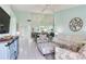Inviting living area with a TV, comfortable seating, and a mirrored wall reflecting the dining area at 6171 Bahia Del Mar Blvd # 216, St Petersburg, FL 33715