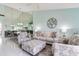 Cozy living room featuring ample seating, an ornate mirror wall, and an open floor plan at 6171 Bahia Del Mar Blvd # 216, St Petersburg, FL 33715