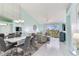 Open-concept living room featuring a dining area and glass sliding doors to a patio at 6171 Bahia Del Mar Blvd # 216, St Petersburg, FL 33715