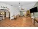 Spacious living room featuring wood floors and stone fireplace with open access to the dining room at 6259 68Th N Ter, Pinellas Park, FL 33781