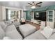 Comfortable living room featuring a large sectional sofa, ceiling fan, and neutral decor at 6259 68Th N Ter, Pinellas Park, FL 33781