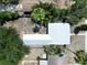 A bird's eye view features a well maintained home with a light metal roof and ample green space surrounding the property at 627 64Th S Ave, St Petersburg, FL 33705