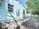 View of the side of the house with greenery and a walkway at 627 64Th S Ave, St Petersburg, FL 33705