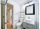 Bright bathroom featuring stylish gray vanity, modern sink, and tiled floors at 627 64Th S Ave, St Petersburg, FL 33705