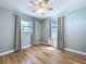 View of bedroom featuring ceiling fan, wood floors, neutral walls, and windows at 627 64Th S Ave, St Petersburg, FL 33705