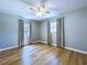 View of bedroom featuring ceiling fan, wood floors, neutral walls, and windows at 627 64Th S Ave, St Petersburg, FL 33705