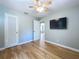 View of bedroom featuring ceiling fan, wood floors, neutral walls, TV, and closet at 627 64Th S Ave, St Petersburg, FL 33705