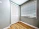 Bright bedroom features light-colored walls, wood-look flooring, and closet with white bi-fold doors at 627 64Th S Ave, St Petersburg, FL 33705
