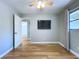 View of bedroom featuring ceiling fan, wood floors, neutral walls, and TV at 627 64Th S Ave, St Petersburg, FL 33705