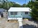 Inviting single-story home with a bright metal roof and a tidy landscaped front yard at 627 64Th S Ave, St Petersburg, FL 33705