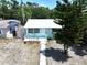 Inviting home features a metal roof, well-kept lawn, and a cozy porch at 627 64Th S Ave, St Petersburg, FL 33705