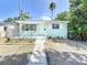 Inviting single-story home featuring a tidy front yard and a welcoming walkway to the front door at 627 64Th S Ave, St Petersburg, FL 33705