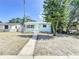 Inviting single-story home featuring a tidy front yard and a welcoming walkway to the front door at 627 64Th S Ave, St Petersburg, FL 33705