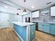 Well-lit kitchen with an island featuring a quartz countertop and stainless steel appliances at 627 64Th S Ave, St Petersburg, FL 33705