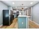 Spacious kitchen with stainless steel appliances, white cabinets, and a large island at 627 64Th S Ave, St Petersburg, FL 33705