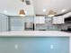 Spacious kitchen featuring a large quartz countertop island and pendant lighting at 627 64Th S Ave, St Petersburg, FL 33705