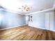 Bright living room with hardwood floors, a ceiling fan, and fresh paint at 627 64Th S Ave, St Petersburg, FL 33705