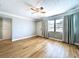 Bright living room featuring hardwood floors, fan and natural light with curtains at 627 64Th S Ave, St Petersburg, FL 33705