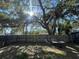 Spacious backyard features a mature tree and a weathered wooden fence for privacy at 701 54Th S St, Gulfport, FL 33707
