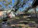 Backyard with a wooden fence, tree coverage, and room for outdoor activities and grilling at 701 54Th S St, Gulfport, FL 33707