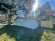 Side view of home with fresh grass, a fence and shady mature trees at 701 54Th S St, Gulfport, FL 33707