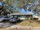 Quaint single-Gathering home featuring a metal roof and a well-manicured front lawn at 701 54Th S St, Gulfport, FL 33707