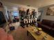 Comfortable living room featuring tile floors, a brown leather couch, and unique decorative shelving at 701 54Th S St, Gulfport, FL 33707