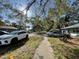 Neighborhood street view showcasing homes with manicured lawns and mature trees at 701 54Th S St, Gulfport, FL 33707
