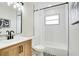 Tastefully updated bathroom with wood vanity, black fixtures, tub and shower at 8277 82Nd N Ave, Largo, FL 33777