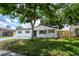 Charming renovated single-story home with new driveway and fresh landscaping and black trim at 8277 82Nd N Ave, Largo, FL 33777