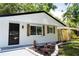 Close up of the renovated single-story home featuring black trim, black door, and manicured yard at 8277 82Nd N Ave, Largo, FL 33777