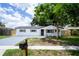 Charming renovated single-story home with new driveway and fresh landscaping and black trim at 8277 82Nd N Ave, Largo, FL 33777