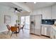 Eat-in kitchen with stainless steel refrigerator, adjacent dining area, and screened patio access at 8277 82Nd N Ave, Largo, FL 33777