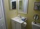 Half bath featuring a vanity with sink, mirror, and toilet at 860 Virginia St # 308, Dunedin, FL 34698