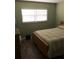 Cozy bedroom with natural light, hardwood floors, and warm tones at 860 Virginia St # 308, Dunedin, FL 34698