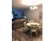 Open floor plan living room and dining room features wood-look flooring and modern chandelier at 860 Virginia St # 308, Dunedin, FL 34698