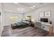 Bright bedroom with wood-look floors, ceiling fan, and desk area, offering style and functionality at 4210 E Grove St, Tampa, FL 33610