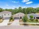 A high angle shot of this single story home situated in a neighborhood with mature trees at 10563 Laguna Plains Dr, Riverview, FL 33578