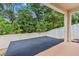 An outdoor patio area with wooden deck surrounded by a white fence and lush green trees at 10563 Laguna Plains Dr, Riverview, FL 33578