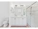 Well-lit bathroom boasting a dual vanity, large mirror, and a glass shower at 10563 Laguna Plains Dr, Riverview, FL 33578