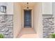 The front entryway features stone accents and a stylish dark-colored front door at 10563 Laguna Plains Dr, Riverview, FL 33578