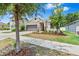 Charming single-story home featuring a well-manicured lawn and stone veneer accents at 10563 Laguna Plains Dr, Riverview, FL 33578