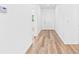 Bright hallway showcases the beautiful light wood-look flooring and neutral color palette at 10563 Laguna Plains Dr, Riverview, FL 33578